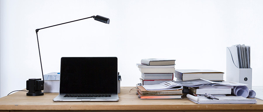 A desk with lamp and laptop