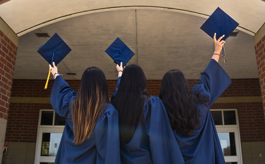 Three women in graduation gowns