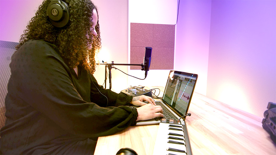 Monica wearing headphones at desk