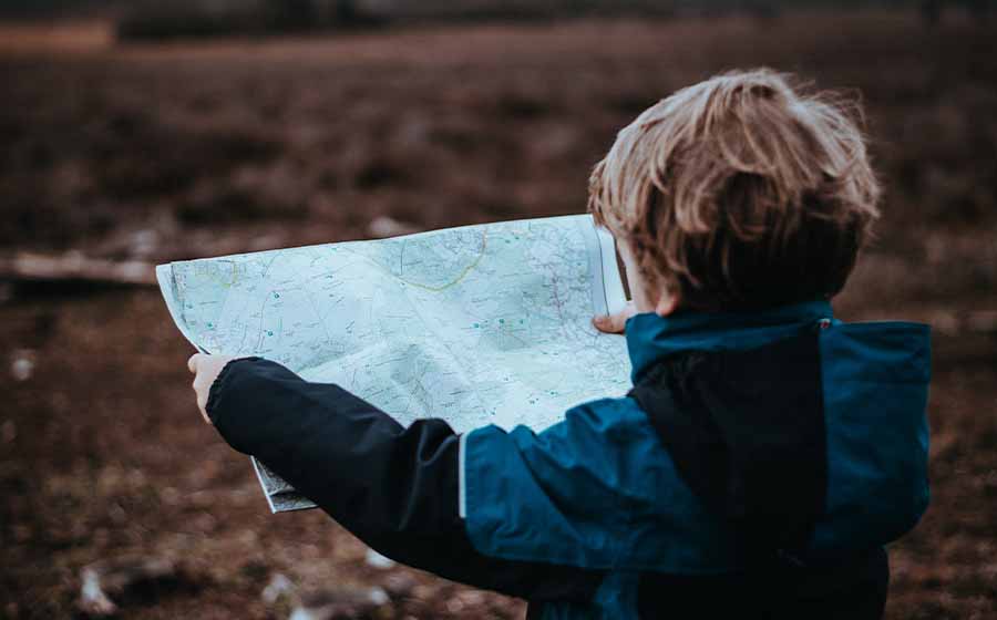 A boy looks at a map